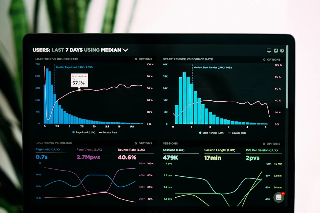 Hands typing on a laptop with cryptocurrency charts and smartphone display in view, focusing on digital finance.